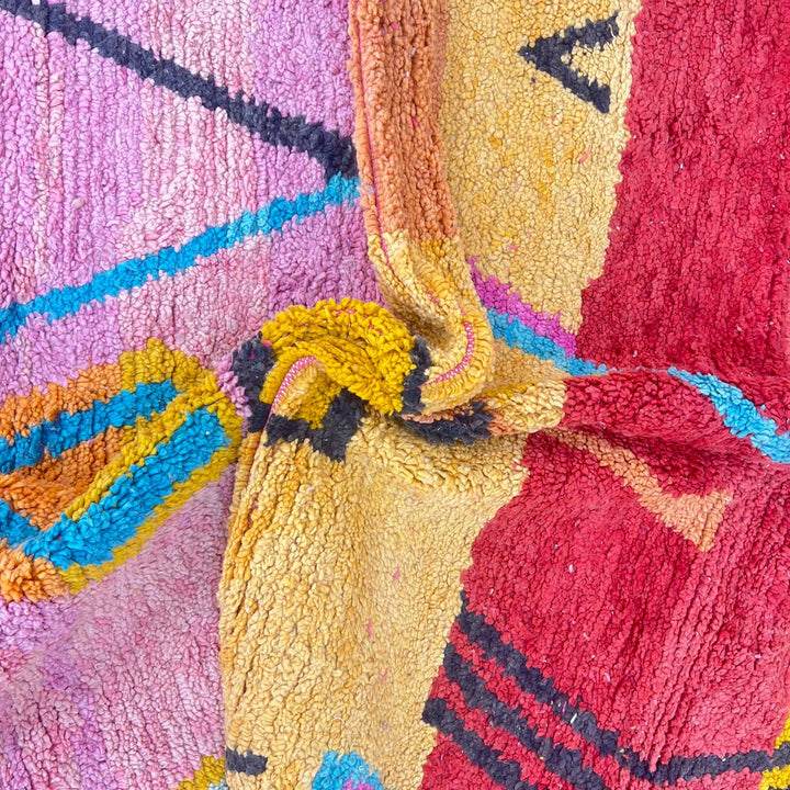 Vintage Moroccan wool rug with abstract Berber tribal symbols in mustard, terracotta and blush pink, handmade in Morocco.