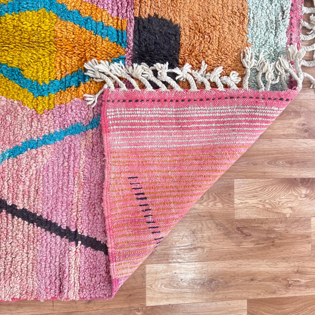 Vintage Moroccan wool rug with abstract Berber tribal symbols in mustard, terracotta and blush pink, handmade in Morocco.