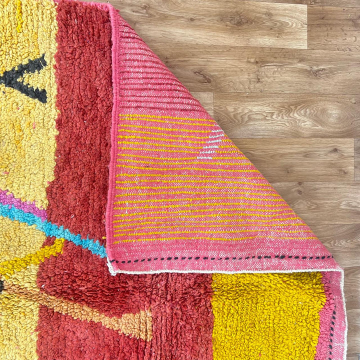 Vintage Moroccan wool rug with abstract Berber tribal symbols in mustard, terracotta and blush pink, handmade in Morocco.