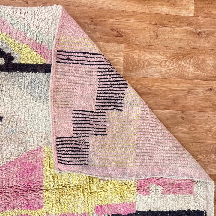 Vintage Moroccan wool rug with minimal abstract Berber patterns in ivory, blush and soft yellow, handmade in Morocco.
