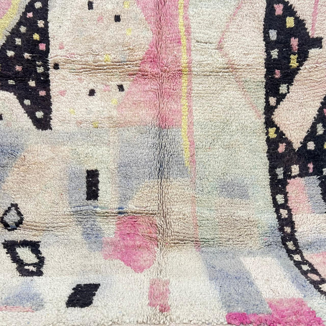 Vintage Moroccan wool rug with minimal abstract Berber patterns in ivory, blush and soft yellow, handmade in Morocco.