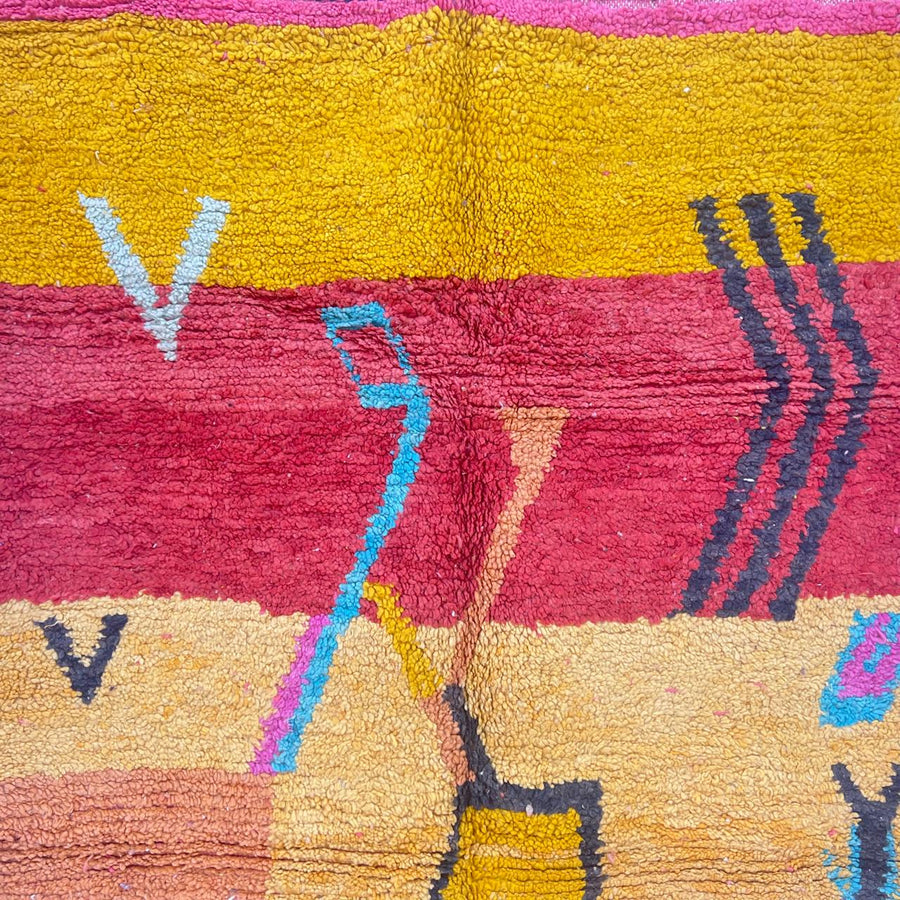 Vintage Moroccan wool rug with abstract Berber tribal symbols in mustard, terracotta and blush pink, handmade in Morocco.
