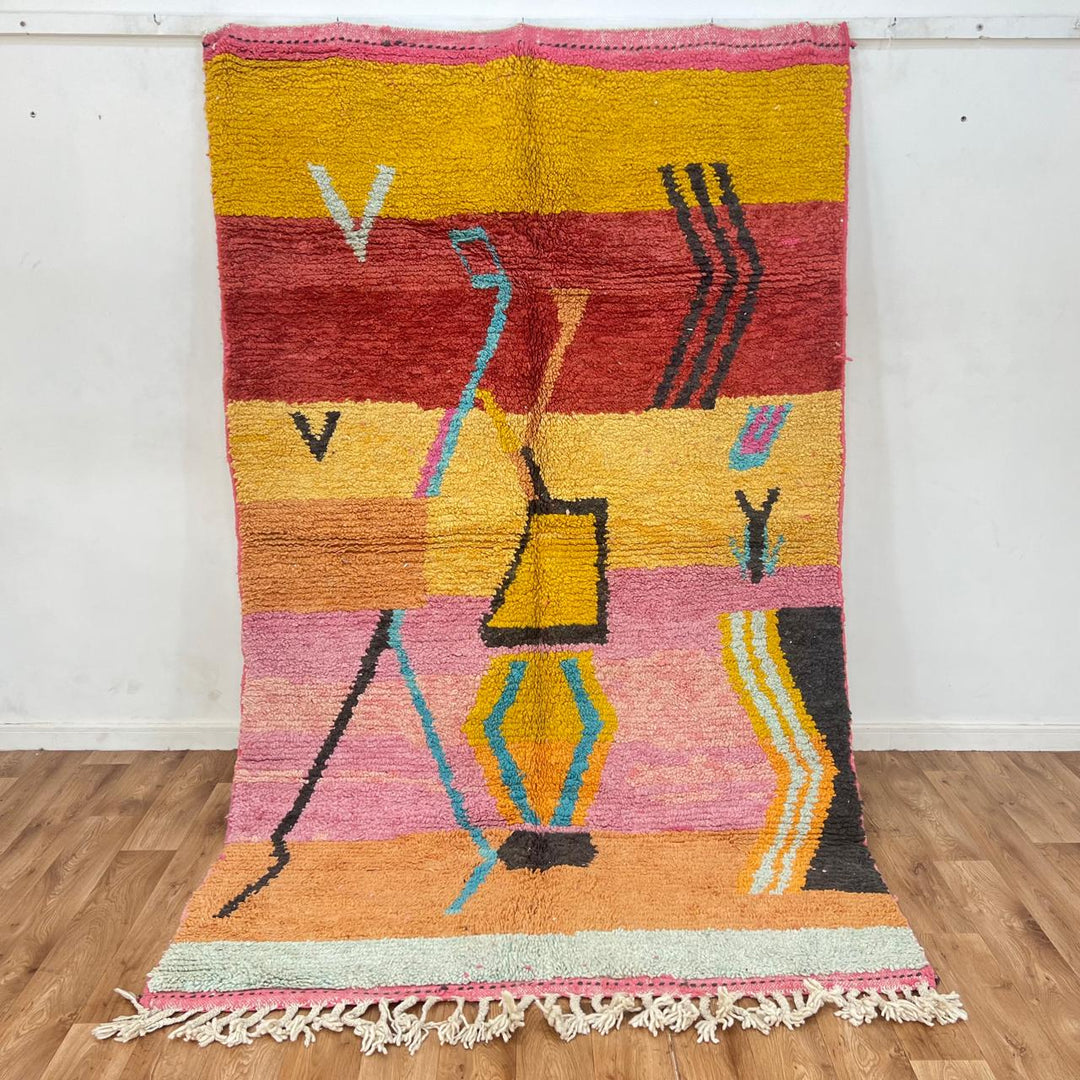 Vintage Moroccan wool rug with abstract Berber tribal symbols in mustard, terracotta and blush pink, handmade in Morocco.