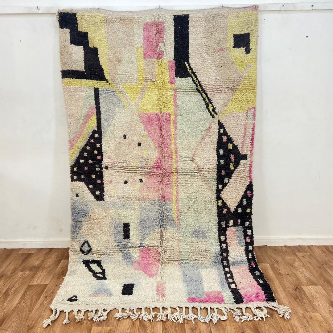 Vintage Moroccan wool rug with minimal abstract Berber patterns in ivory, blush and soft yellow, handmade in Morocco.