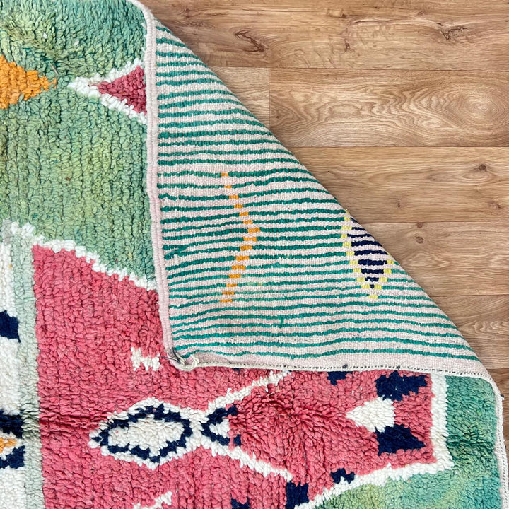 Vintage green Moroccan Berber rug with zigzag stripes and central diamond motif, handmade wool tribal area rug