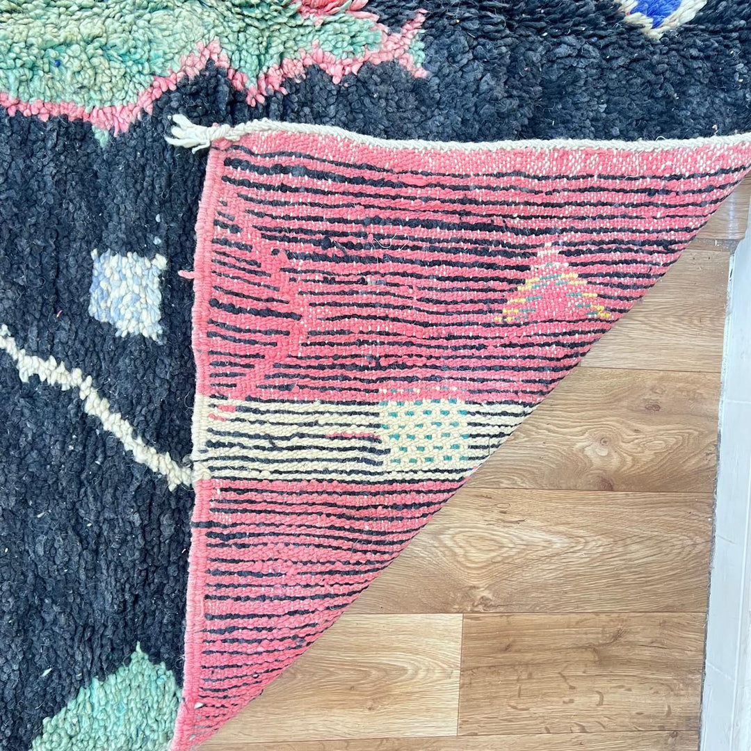 Black vintage Moroccan Berber rug with colorful tribal symbols handwoven in natural wool