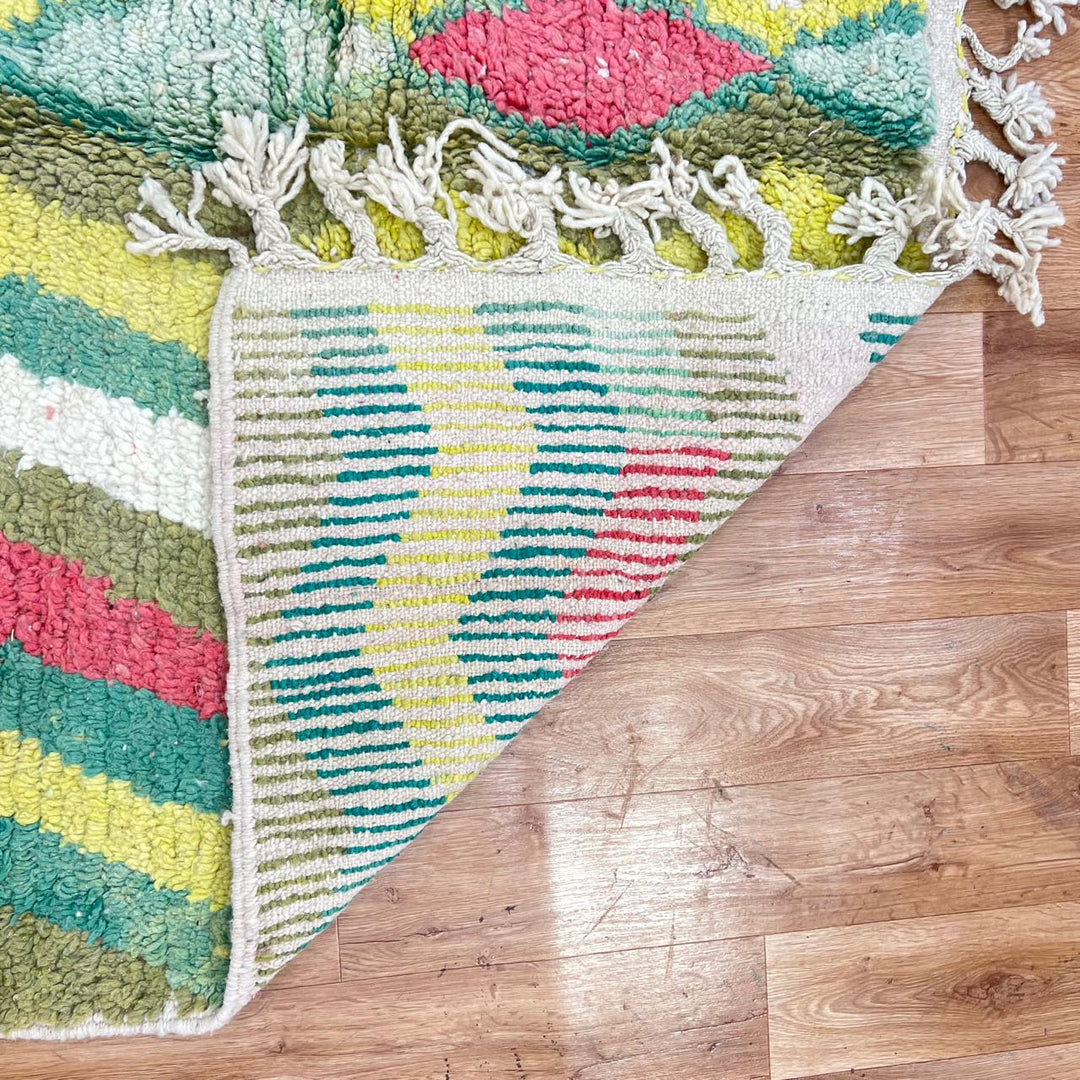 Vintage green Moroccan Berber rug with zigzag stripes and central diamond motif, handmade wool tribal area rug