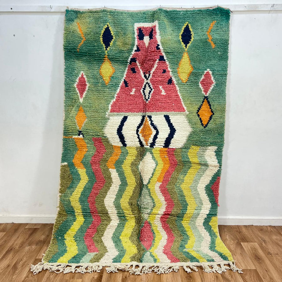 Vintage green Moroccan Berber rug with zigzag stripes and central diamond motif, handmade wool tribal area rug