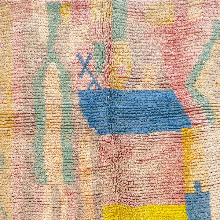 Vintage Moroccan wool rug with pastel abstract Berber motifs in blush, peach and soft blue, handmade in Morocco.