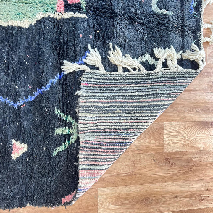 Black vintage Moroccan Berber rug with colorful tribal symbols handwoven in natural wool