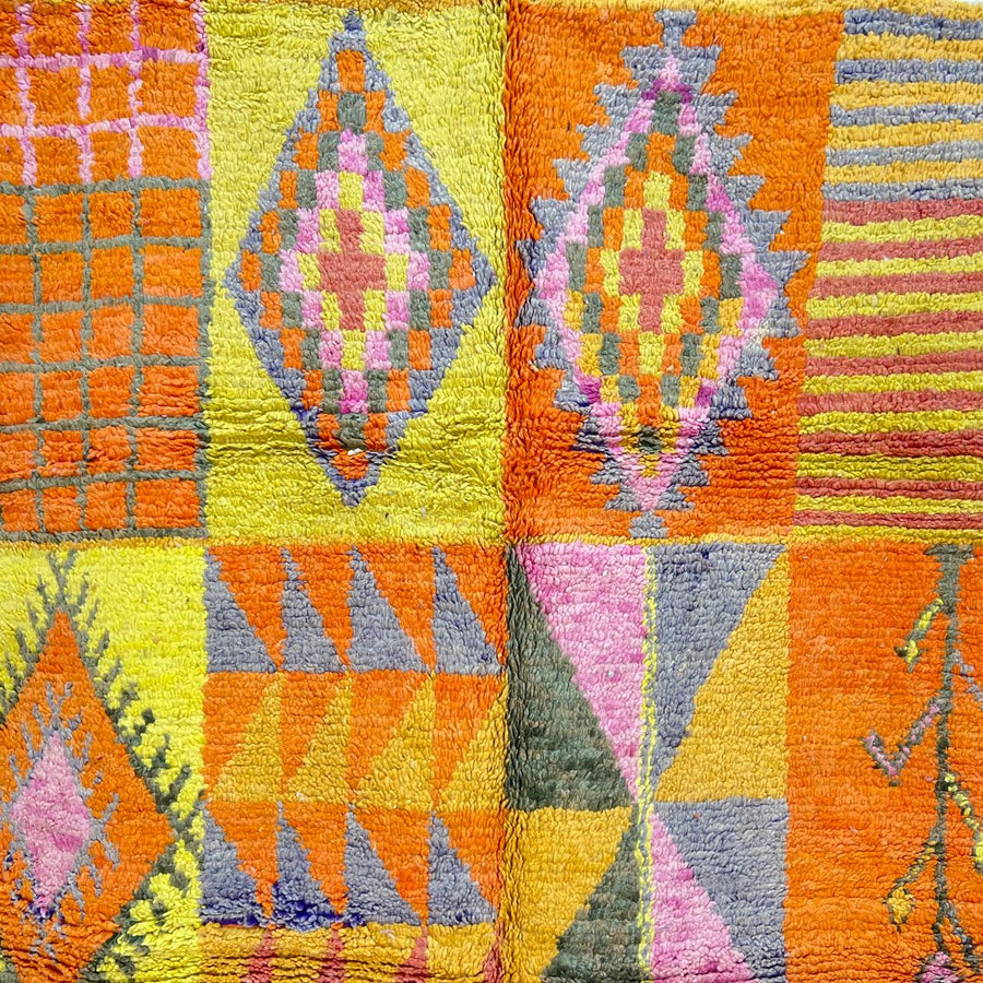 Vintage Moroccan wool rug with colorful geometric patchwork pattern in orange, yellow and pink