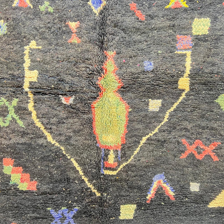 Black vintage Moroccan Berber rug with colorful tribal symbols handwoven in natural wool