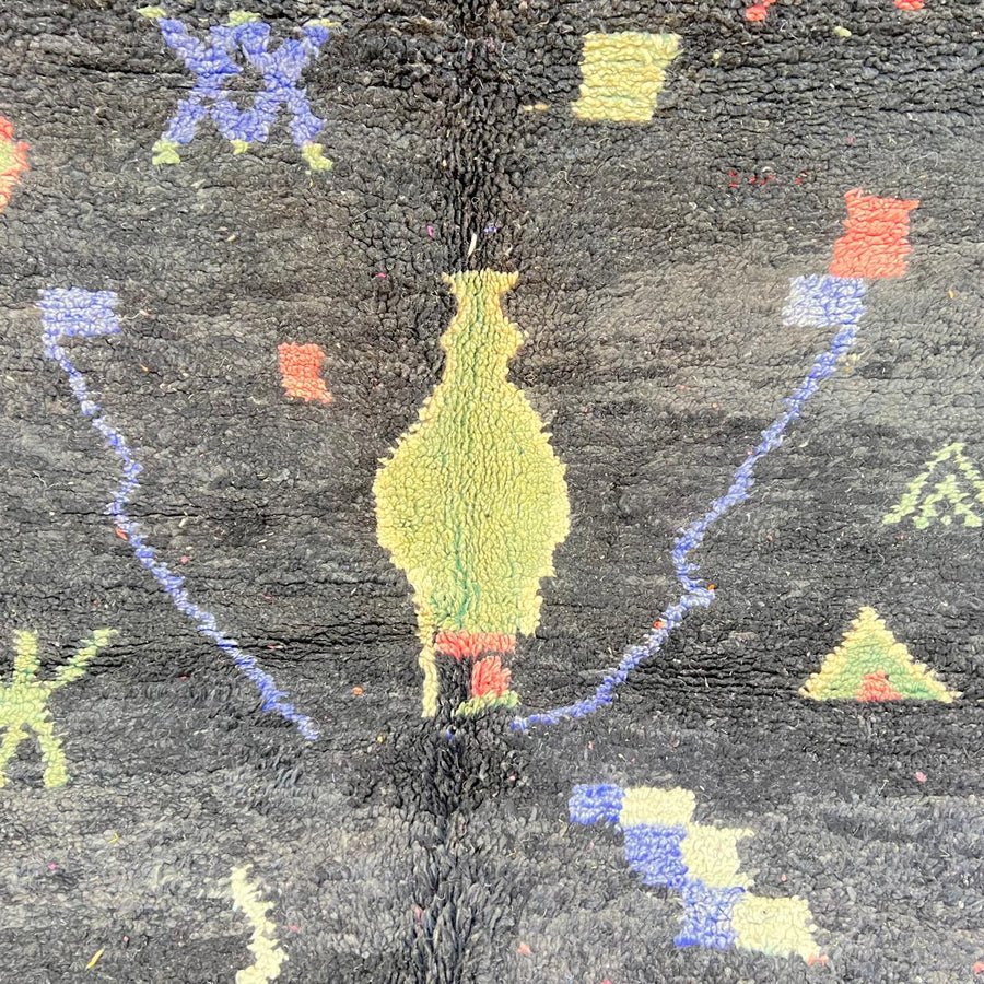 Black vintage Moroccan Berber rug with colorful tribal symbols handwoven in natural wool