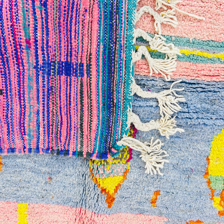 Vintage Moroccan wool rug with blush pink base and abstract Berber line patterns