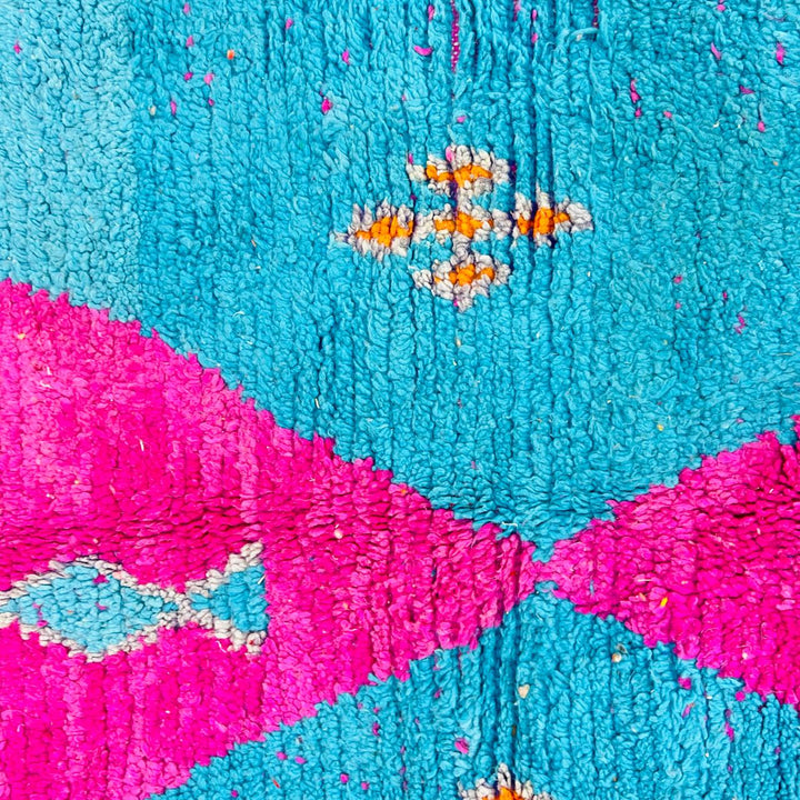 Vintage Moroccan rug with pink and teal geometric Berber design handmade from natural wool