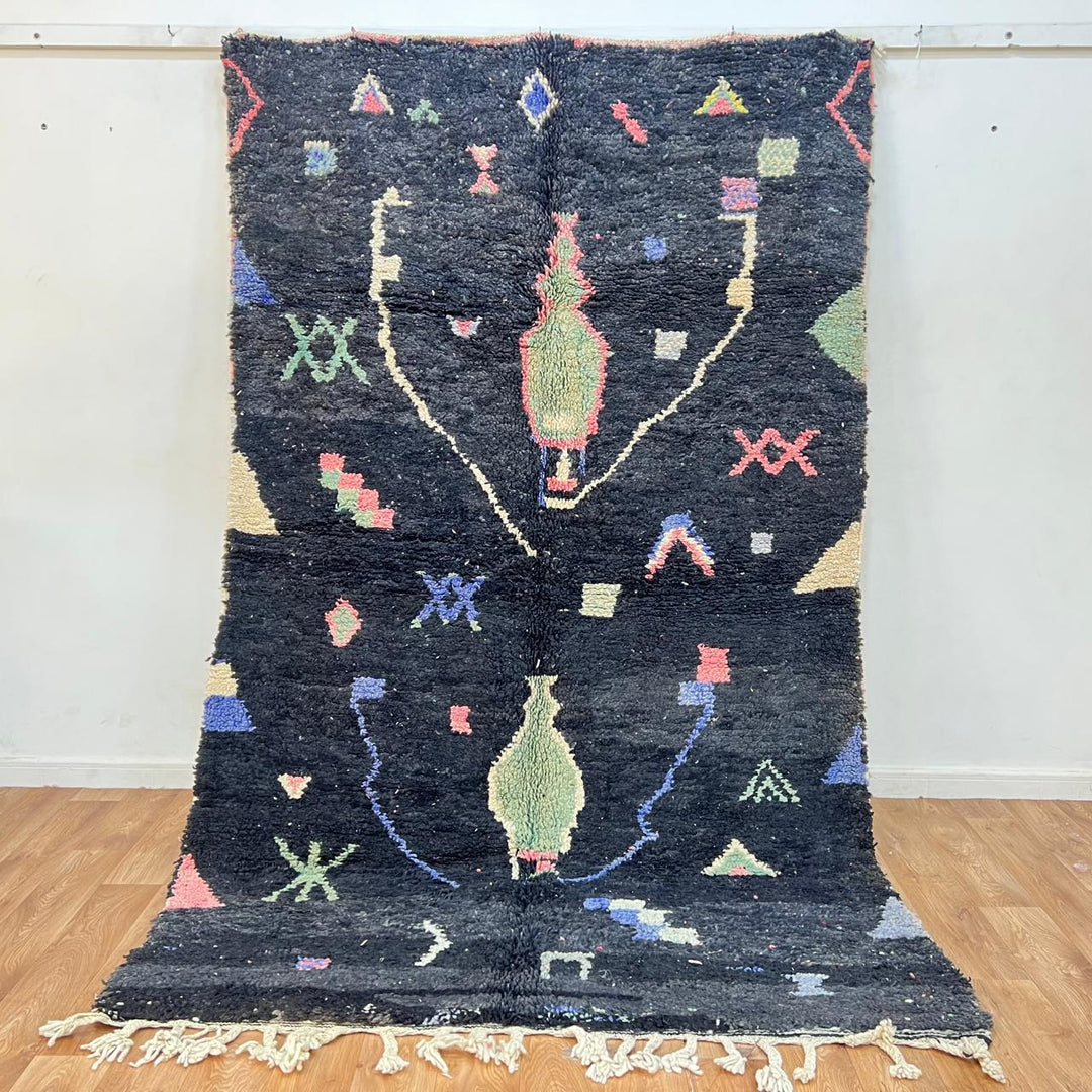 Black vintage Moroccan Berber rug with colorful tribal symbols handwoven in natural wool