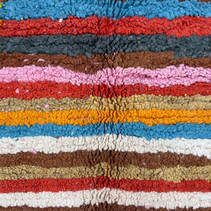 Vintage Moroccan wool rug with pink background and colorful striped central motif, handmade Berber rug 7.97 x 5.87 ft