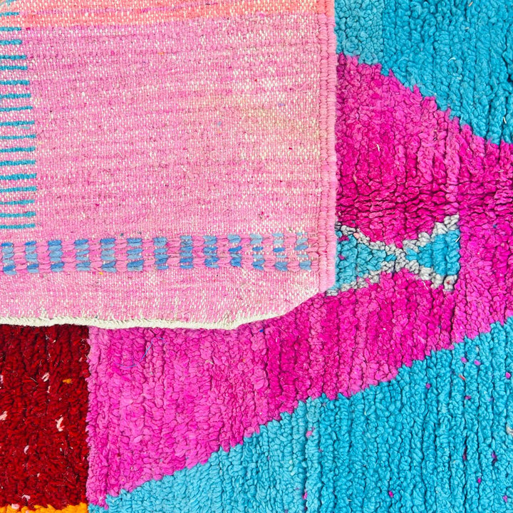Vintage Moroccan rug with pink and teal geometric Berber design handmade from natural wool