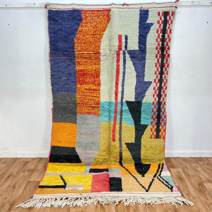 Vintage Moroccan wool rug with abstract color block design in mustard yellow, teal blue, pink, terracotta and ivory, handwoven by Berber artisans in Morocco.
