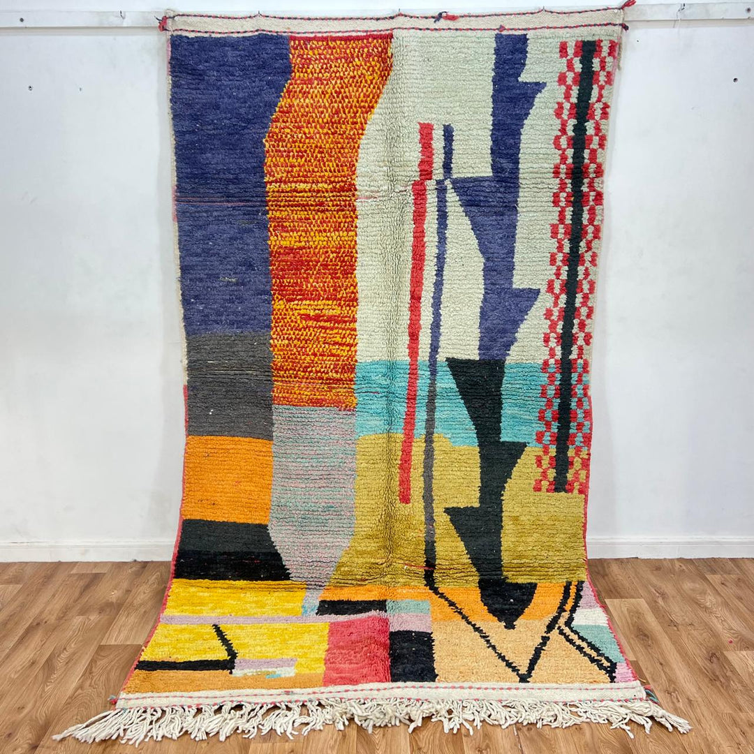 Vintage Moroccan wool rug with abstract color block design in mustard yellow, teal blue, pink, terracotta and ivory, handwoven by Berber artisans in Morocco.