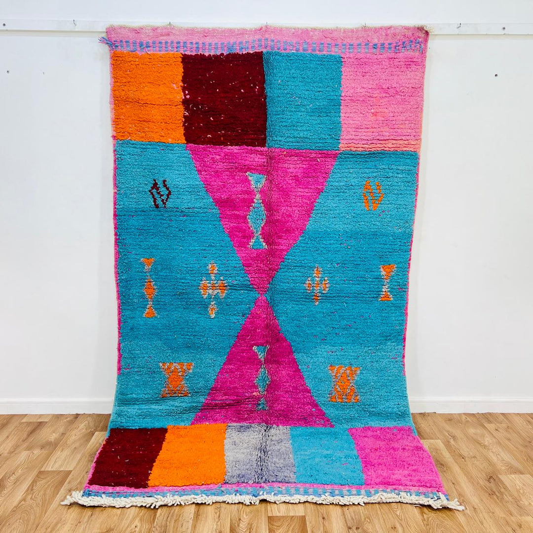 Vintage Moroccan rug with pink and teal geometric Berber design handmade from natural wool