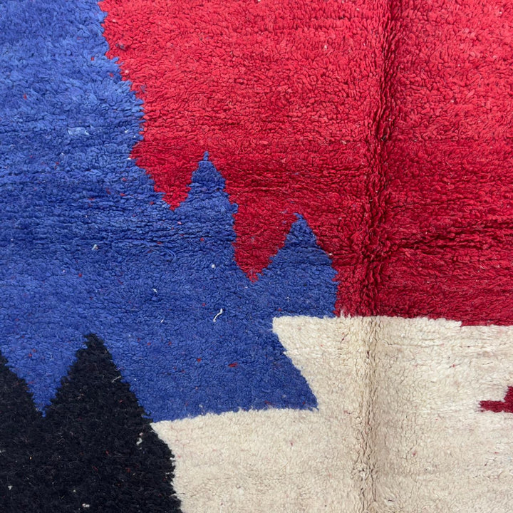 Vintage Moroccan wool rug in deep red with abstract black, ivory, and blue color blocks, handmade Berber rug