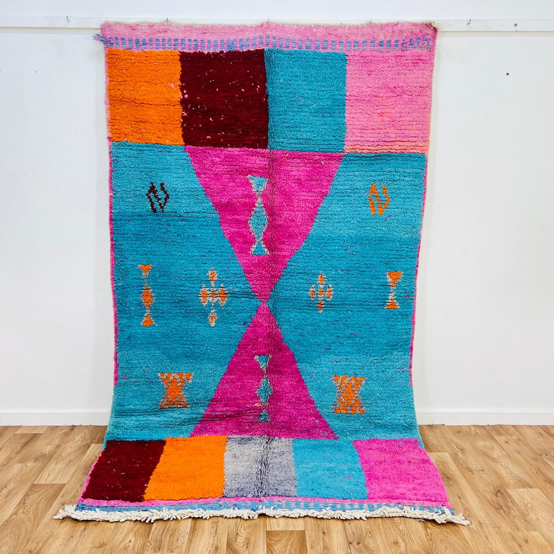 Vintage Moroccan rug with pink and teal geometric Berber design handmade from natural wool