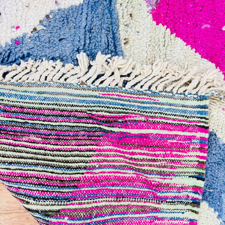 Vintage Moroccan wool rug with abstract Berber geometric pattern in pink, ivory, blue, and black