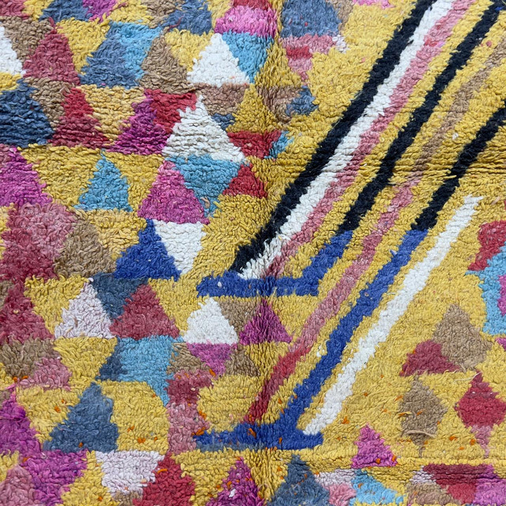 Vintage Moroccan wool rug 8.53x5.25 ft, handmade Berber rug with colorful triangle pattern and bold diagonal stripe design on yellow background
