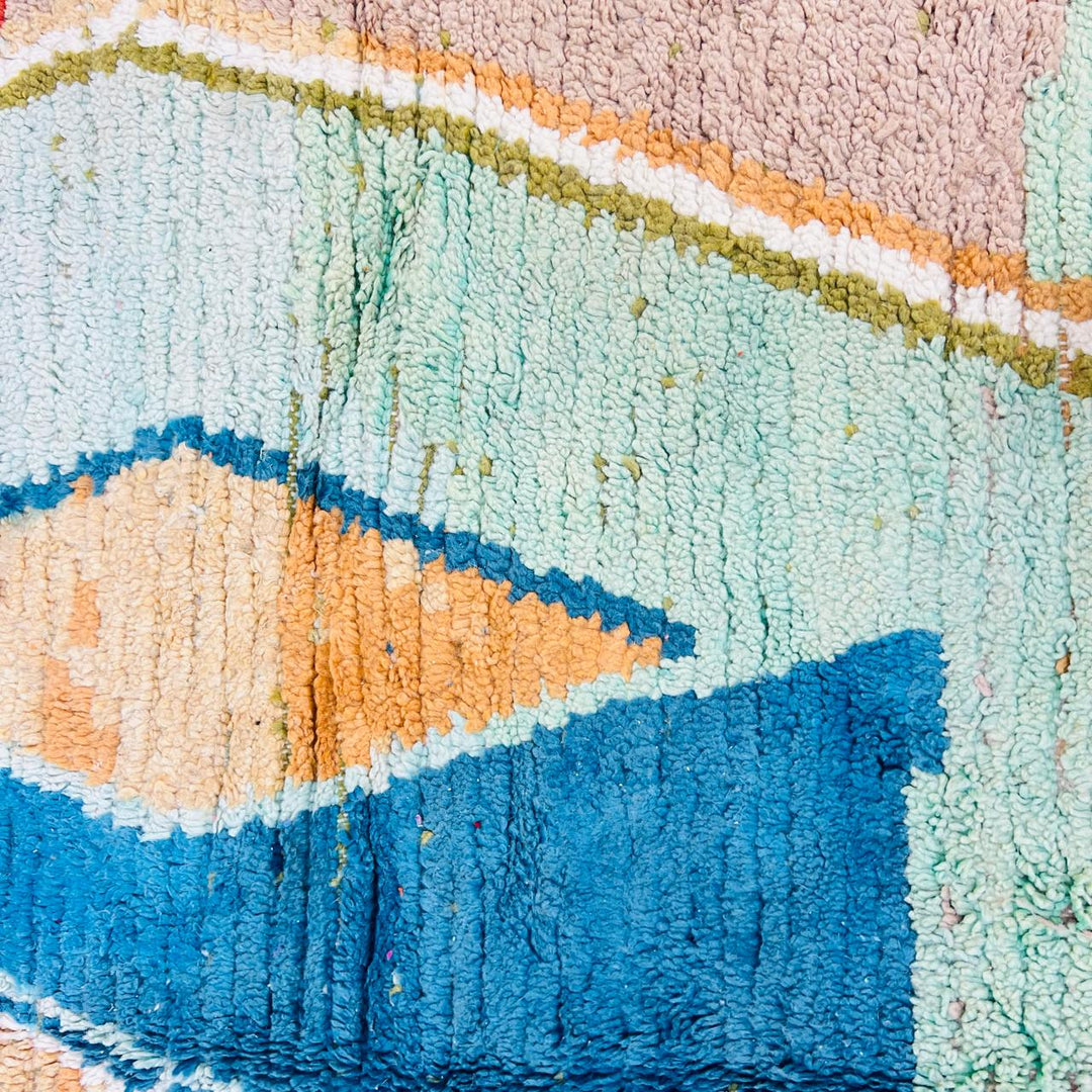 Vintage Moroccan wool rug with pink background and colorful Berber geometric symbols, handmade in Morocco