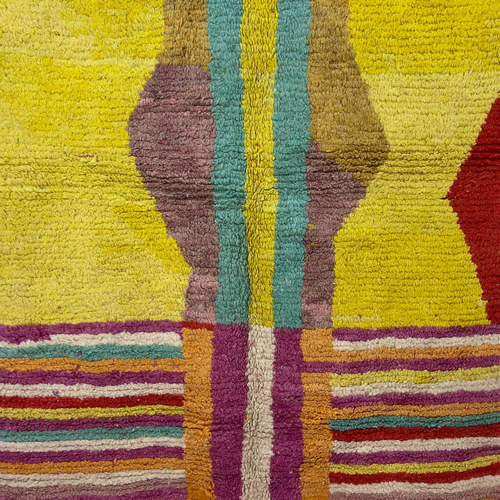 Vintage Moroccan wool rug 8.53x5.84 ft, handmade Berber shag rug with colorful striped pattern and central geometric design in yellow, pink, turquoise and red tones
