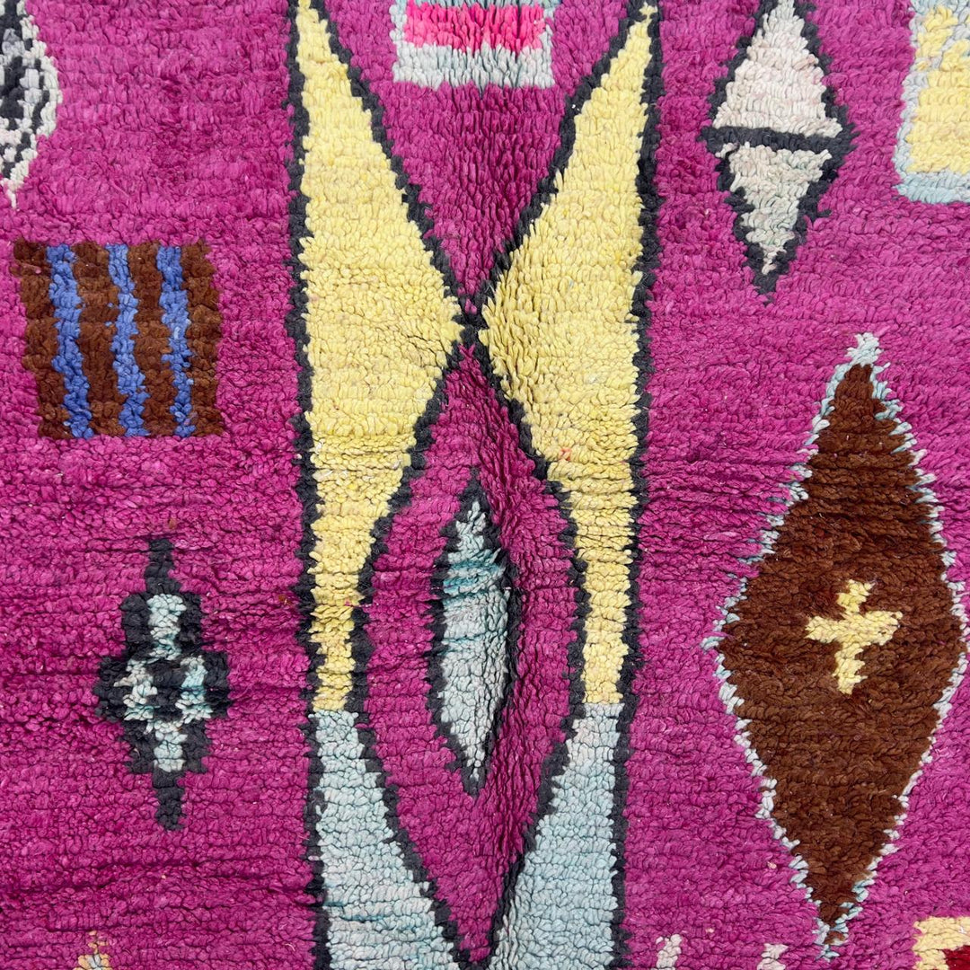 vintage moroccan wool rug with pink background and berber tribal symbols handmade shag rug