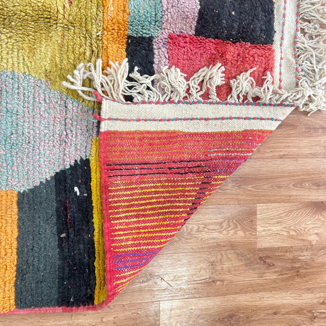 Vintage Moroccan wool rug with abstract color block design in mustard yellow, teal blue, pink, terracotta and ivory, handwoven by Berber artisans in Morocco.
