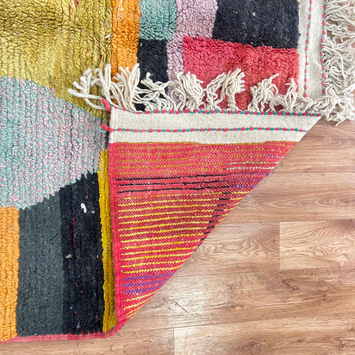 Vintage Moroccan wool rug with abstract color block design in mustard yellow, teal blue, pink, terracotta and ivory, handwoven by Berber artisans in Morocco.