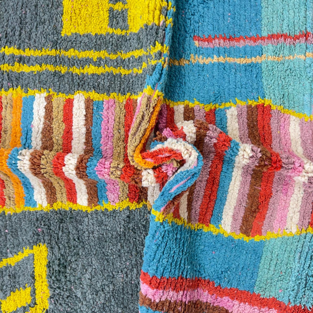 Vintage Moroccan wool rug with pink background and colorful striped central motif, handmade Berber rug 7.97 x 5.87 ft
