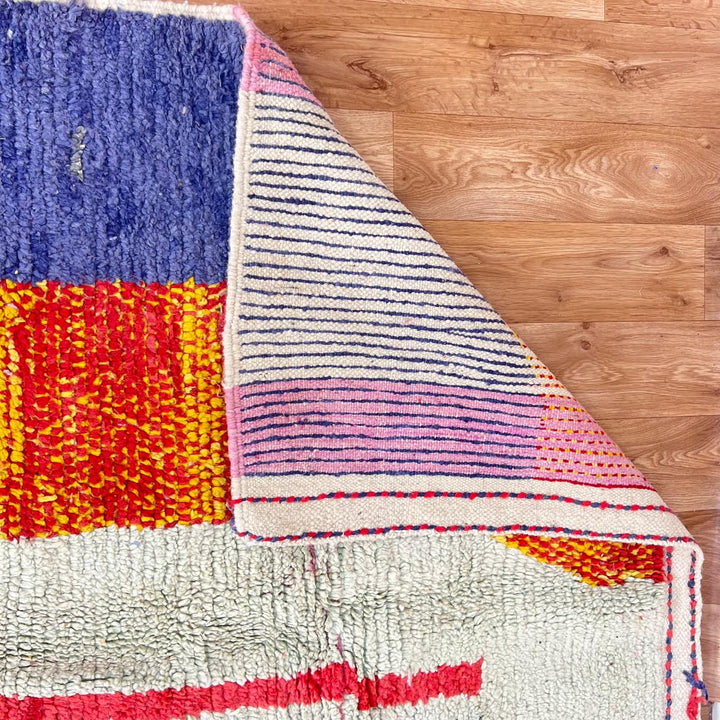 Vintage Moroccan wool rug with abstract color block design in mustard yellow, teal blue, pink, terracotta and ivory, handwoven by Berber artisans in Morocco.
