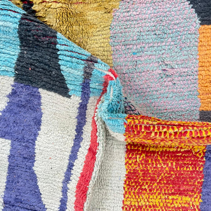 Vintage Moroccan wool rug with abstract color block design in mustard yellow, teal blue, pink, terracotta and ivory, handwoven by Berber artisans in Morocco.