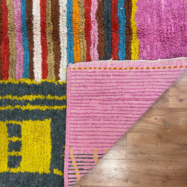 Vintage Moroccan wool rug with pink background and colorful striped central motif, handmade Berber rug 7.97 x 5.87 ft