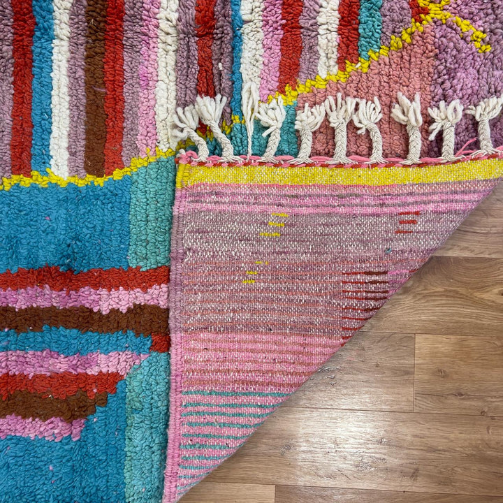 Vintage Moroccan wool rug with pink background and colorful striped central motif, handmade Berber rug 7.97 x 5.87 ft