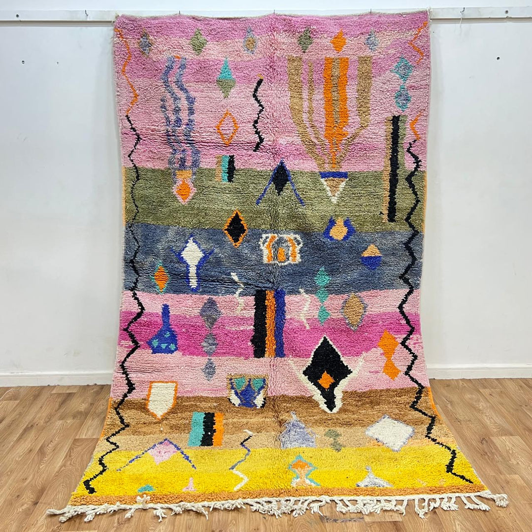 Vintage Moroccan Berber rug with abstract tribal design on pink wool, handmade in Morocco