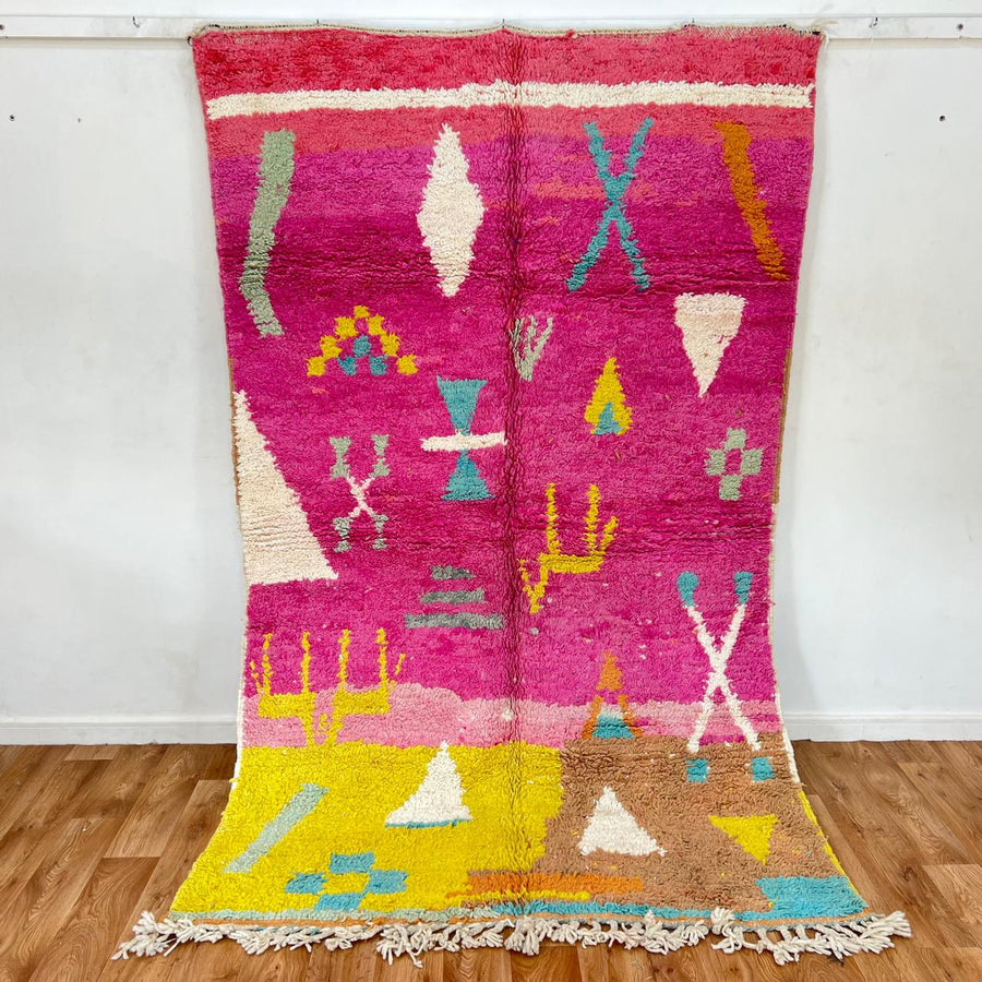 Vintage Moroccan wool rug in pink and yellow tones with abstract Berber geometric patterns, handmade in Morocco