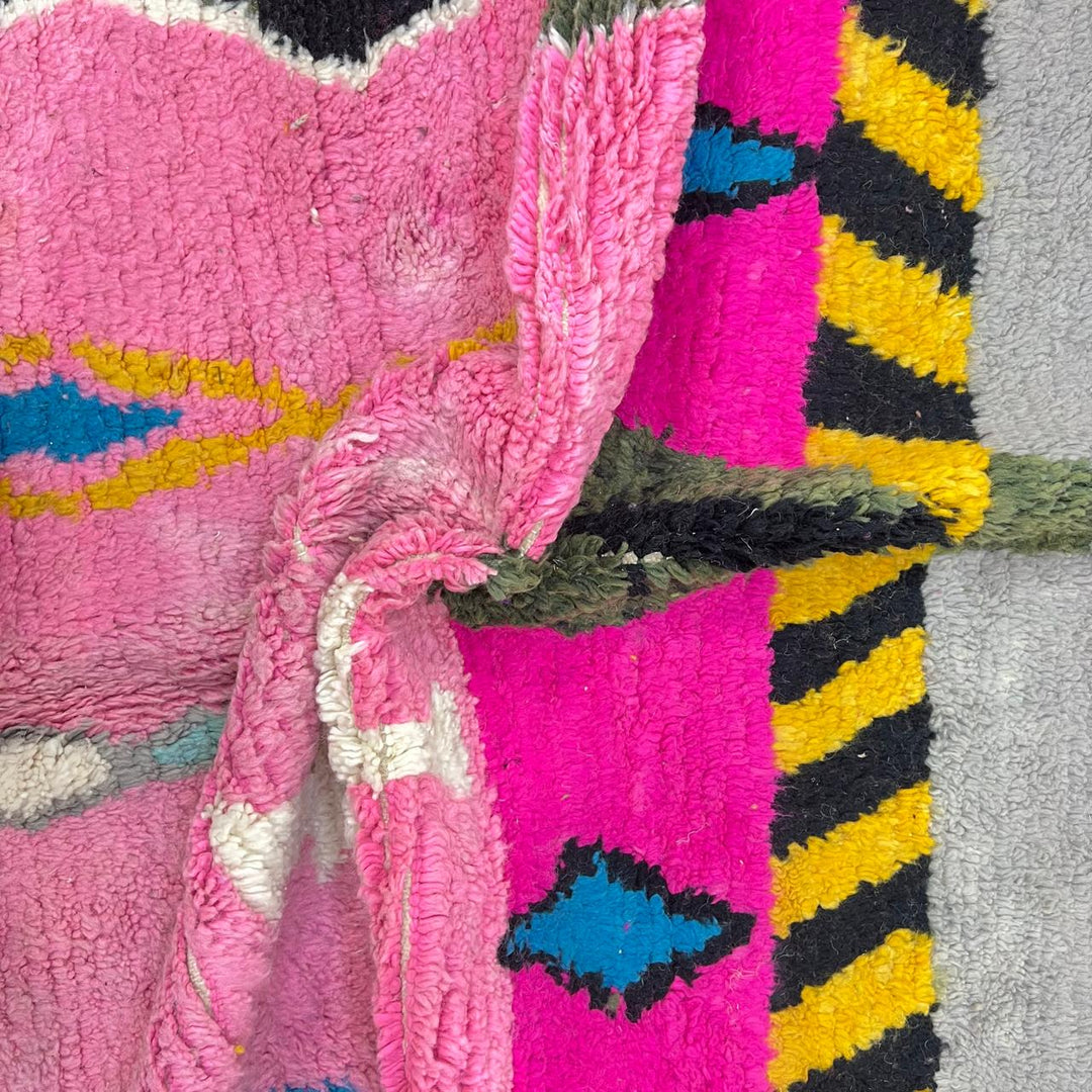 Vintage Moroccan wool rug with pink background and colorful Berber symbols, handmade in Morocco