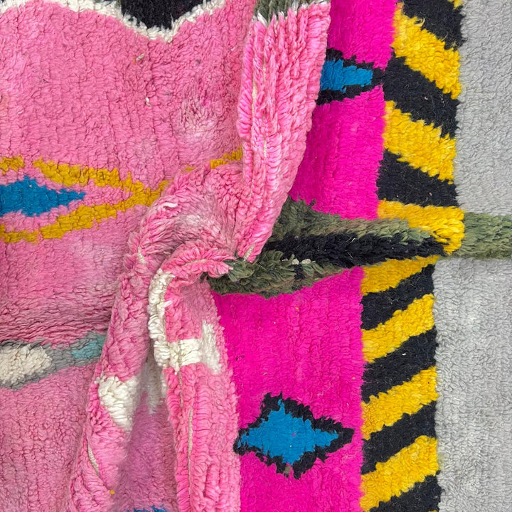 Vintage Moroccan wool rug with pink background and colorful Berber symbols, handmade in Morocco