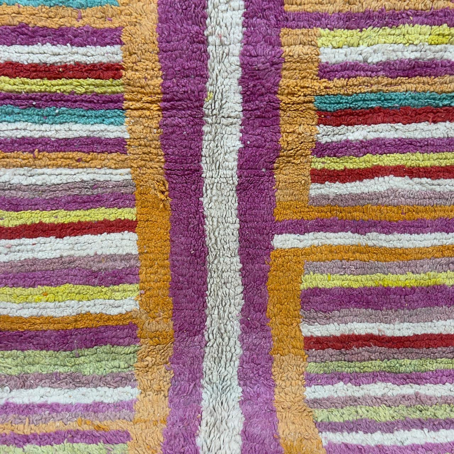 Vintage Moroccan wool rug 8.53x5.84 ft, handmade Berber shag rug with colorful striped pattern and central geometric design in yellow, pink, turquoise and red tones