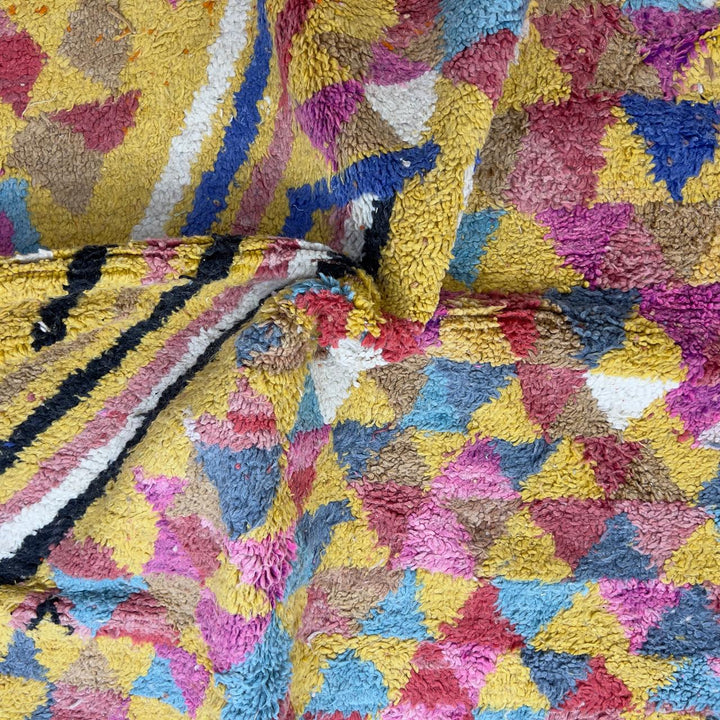 Vintage Moroccan wool rug 8.53x5.25 ft, handmade Berber rug with colorful triangle pattern and bold diagonal stripe design on yellow background
