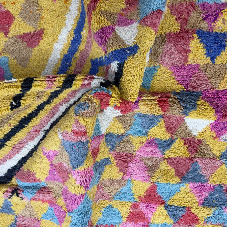 Vintage Moroccan wool rug 8.53x5.25 ft, handmade Berber rug with colorful triangle pattern and bold diagonal stripe design on yellow background
