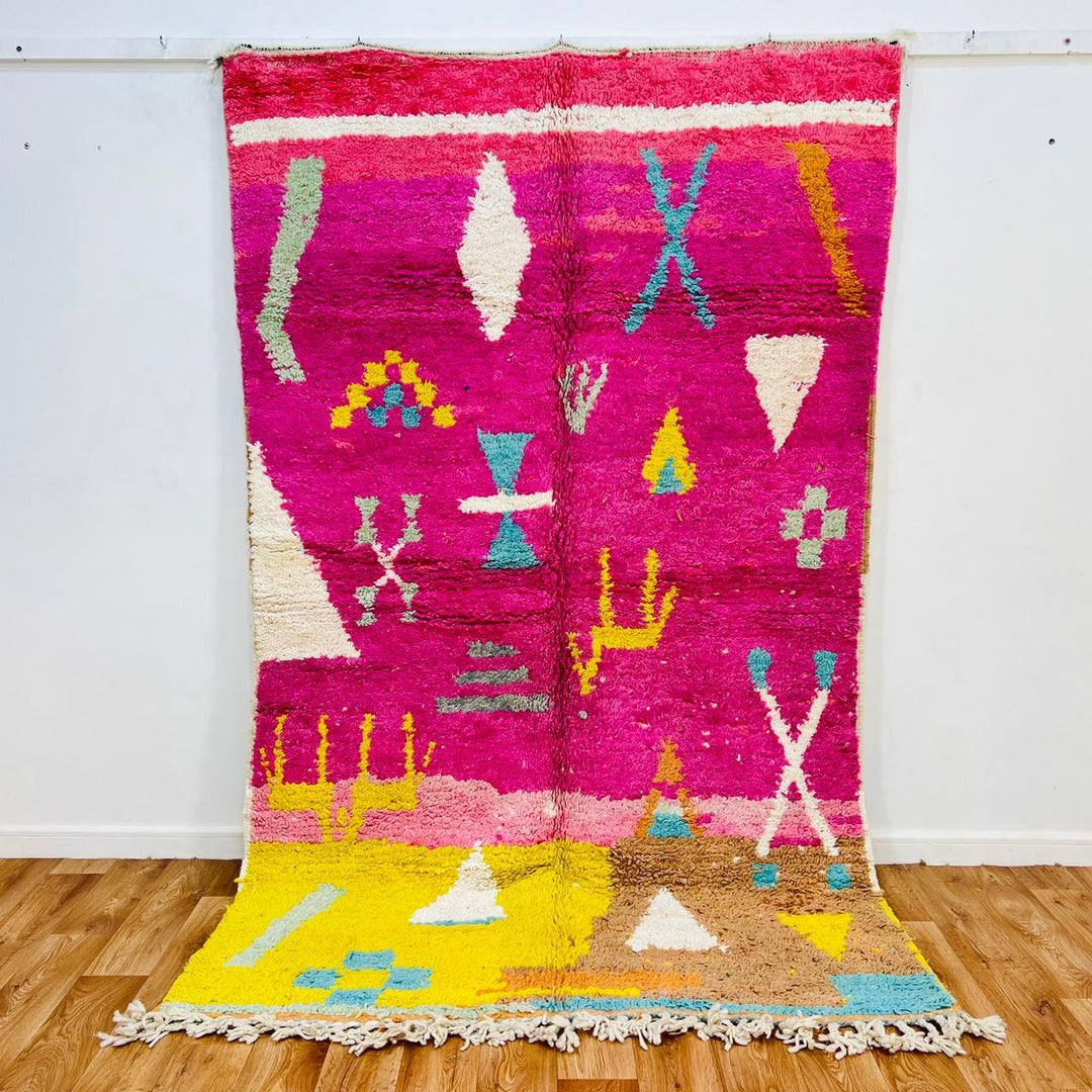 Vintage Moroccan wool rug with pink Berber tribal symbols, handmade in Morocco