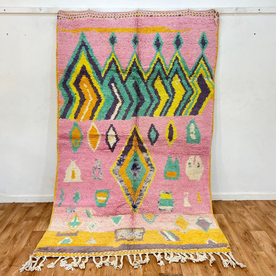 Vintage Moroccan wool rug with colorful Berber geometric pattern on pink background, 260x161 cm