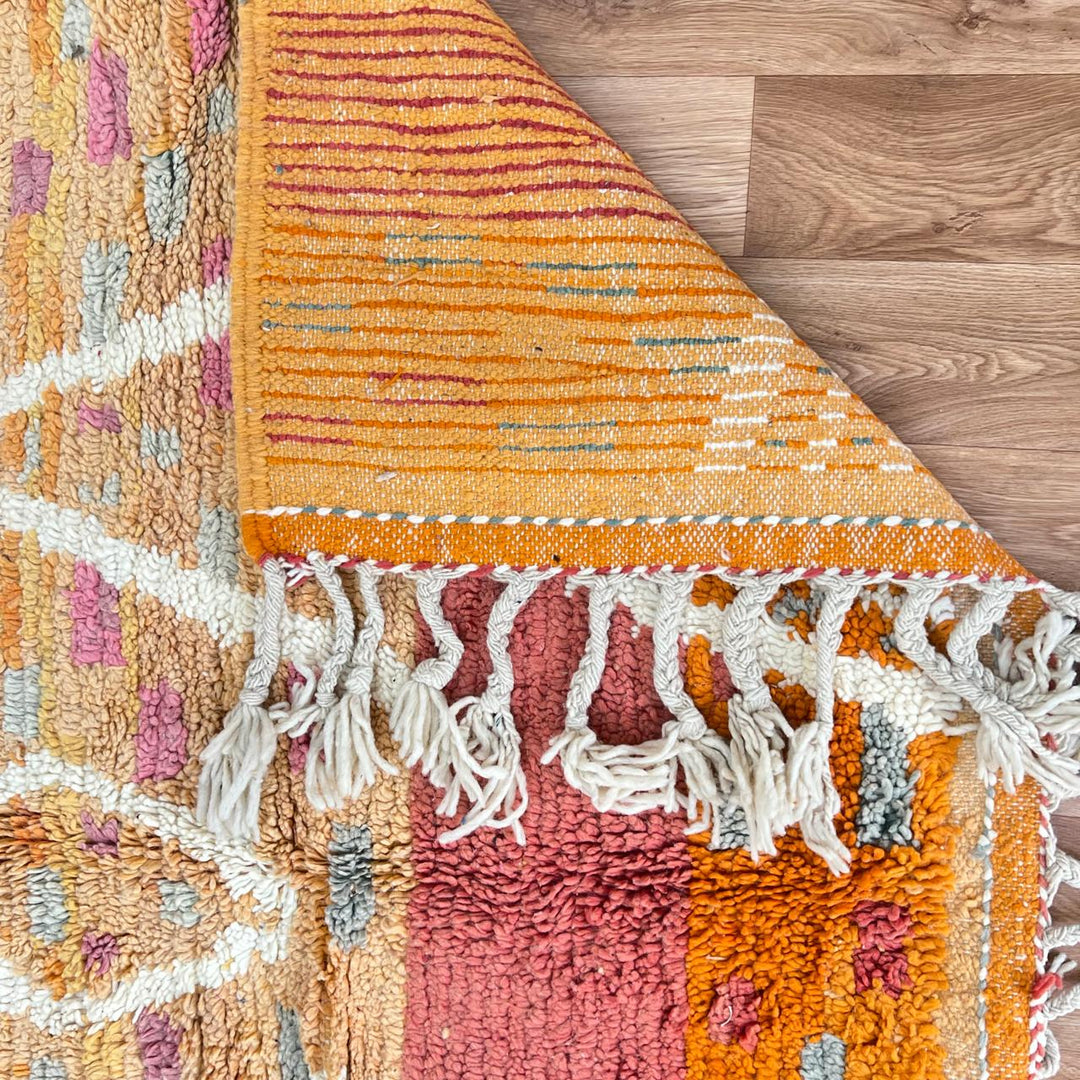 Vintage Moroccan wool rug in orange tones with white Berber diamond patterns, handmade in Morocco