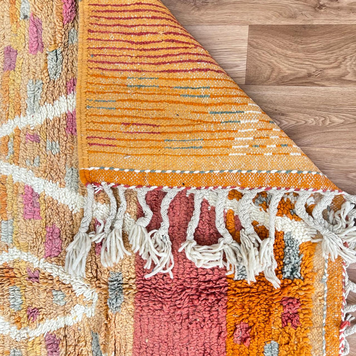 Vintage Moroccan wool rug in orange tones with white Berber diamond patterns, handmade in Morocco